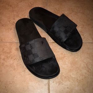 Black Louis Vuitton sandals.